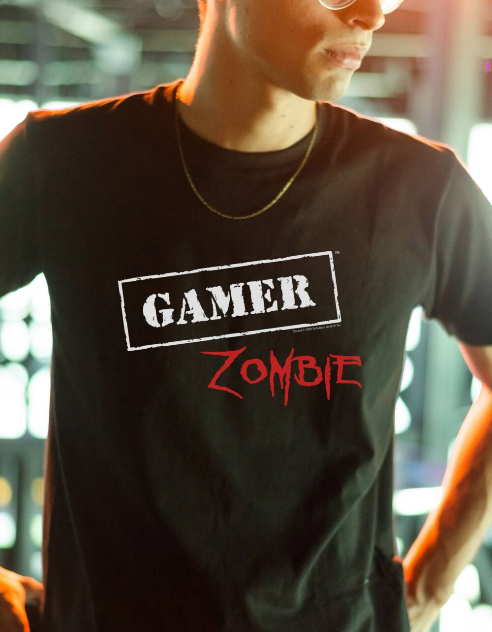 A black shirt with Gamer Zombie written in white on it