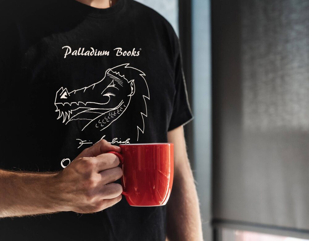 A black shirt with "Palladium Books open house 2015" written in white on it and a picture of Kevin Siembieda's hand drawn dragon head on it