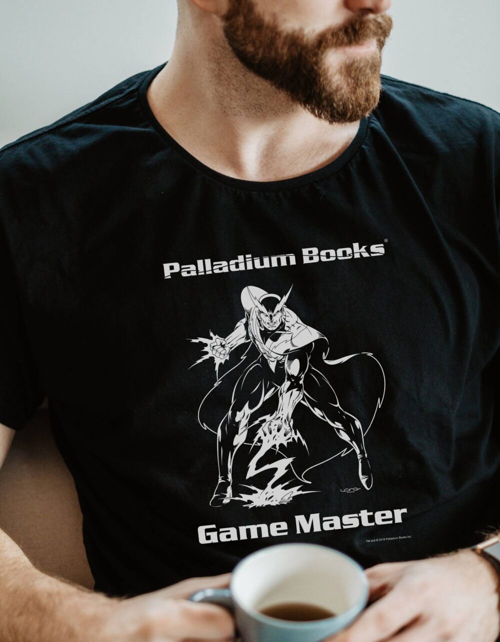 A black shirt with Palladium Books Game Master written in white on it and a picture of the lightning villain from the cover of villains unlimited on it