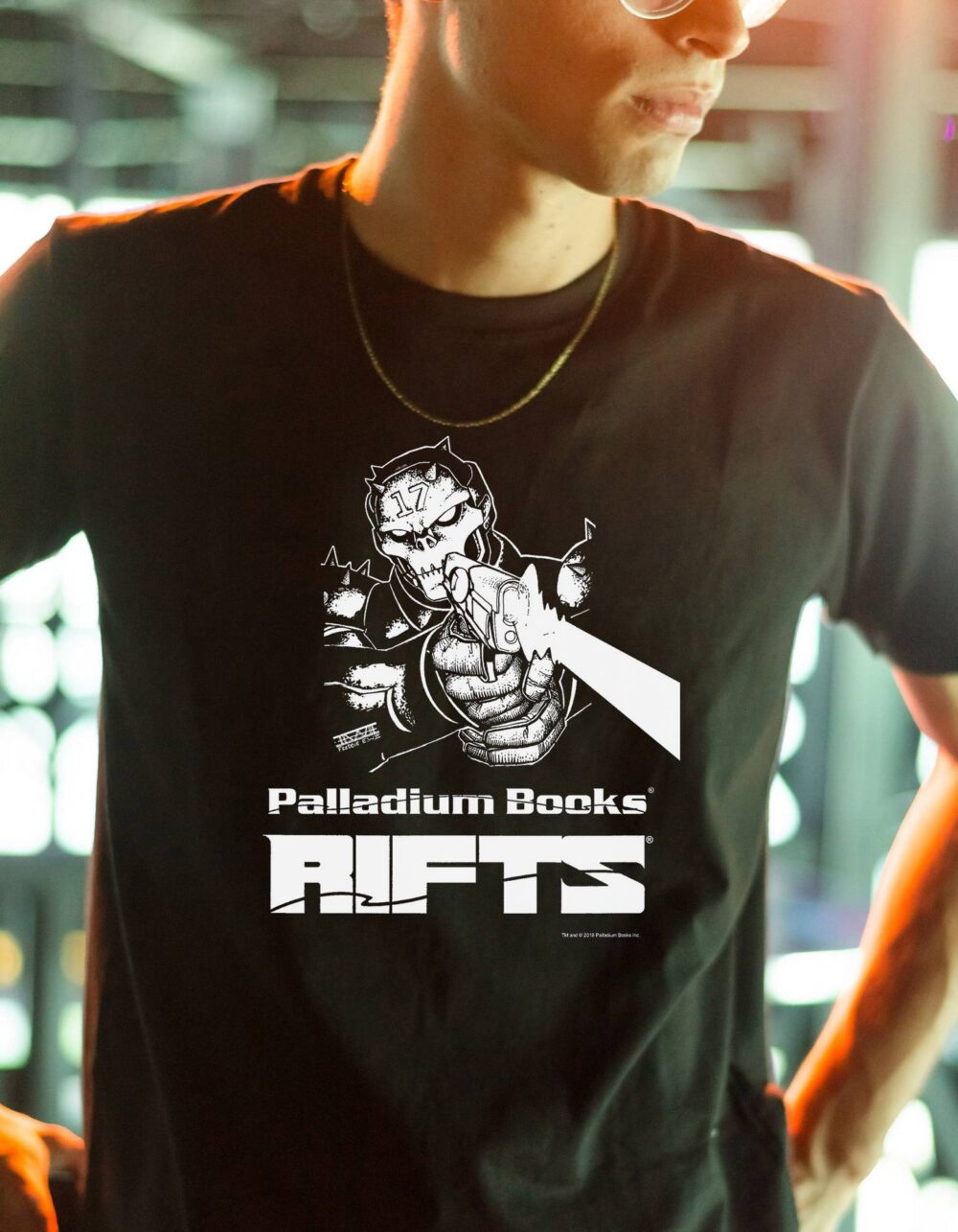 A black shirt with "Palladium Books Rifts" written in white on it, there's also a picture of a coalition soldier firing his laser pistol