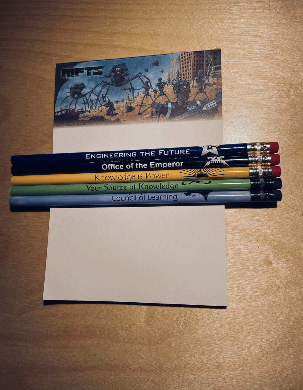 a collection of pencils and a rifts notepad